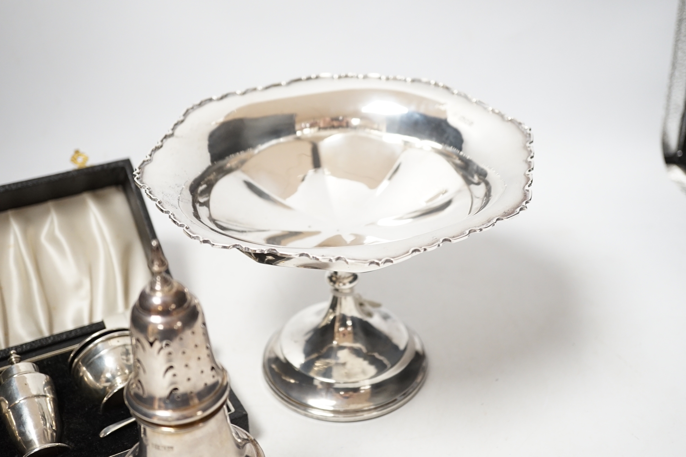 A modern silver baluster sugar caster, Birmingham, 1972, 17.5cm, a cased silver three piece condiment set an a George V silver tazza, weighted.